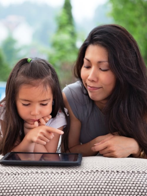 elementary student and mother with tablet