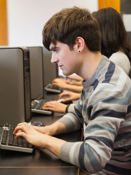 man using computer facing left